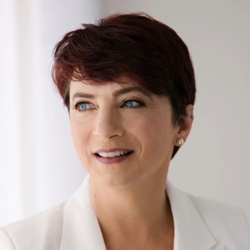 woman in white with short red hair